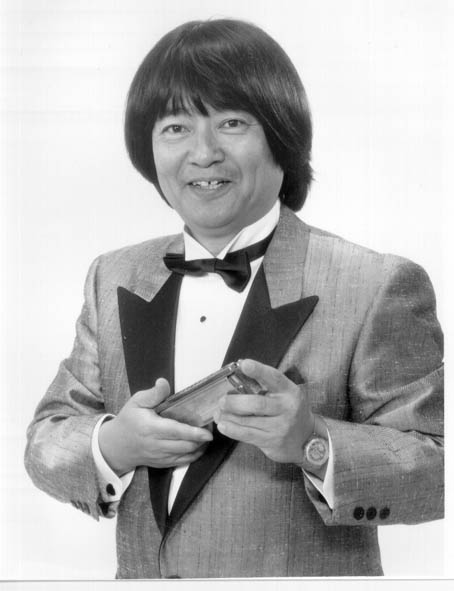 Juko Saito, créateur de l'harmonica trémolo pentatonique, un harmonica en main